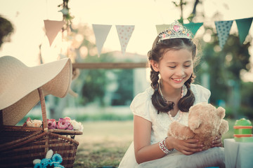 Lovely little princess playing with her teddy bear