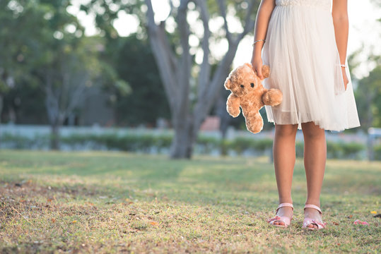 Cropped image of girl carrying toy bear