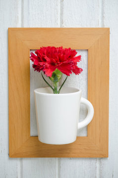 Red Carnation flower in  wooden frame