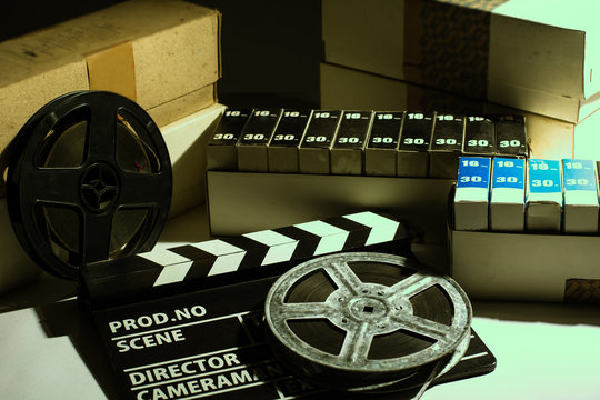 Reel with film and cinema clap