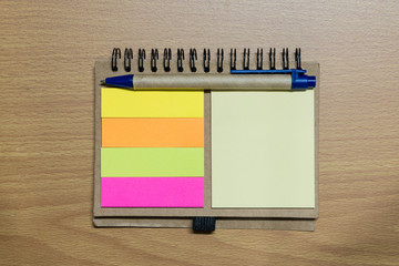 notebook and pen on wood floor