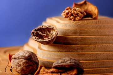 Walnuts and dried fruits on a wooden support in the form of a pyramid
