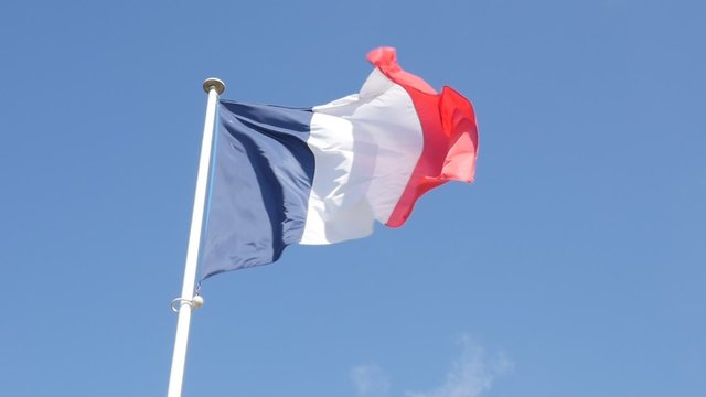 Slow motion French flag in front of blue sky slow waving on wind 1080p FullHD footage - three color flag of France in the wind slow flowing 1920X1080 slow-mo video 
