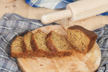 Homemade banana bread sliced on a table . rustic style