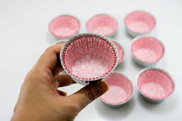 Hand hold aluminium cup of bakery on the white background.