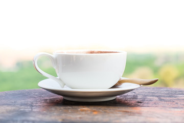 close up a coffee cup on wood table