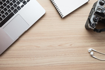 office table with laptop, notebook and camera film. Top view with copy space