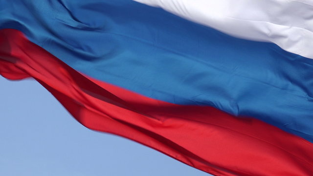 Russian flag blowing in wind with blue sky background, Russia