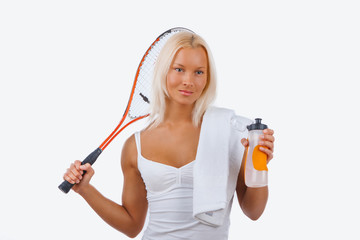 A woman tennis player in a white dress.