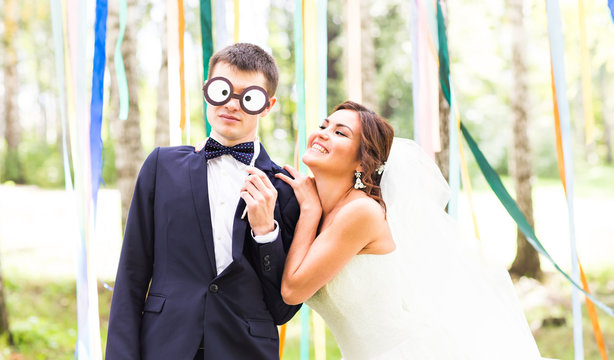 April Fools' Day. Wedding couple have fun with mask.