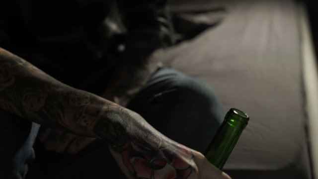 sad young man drinking wine