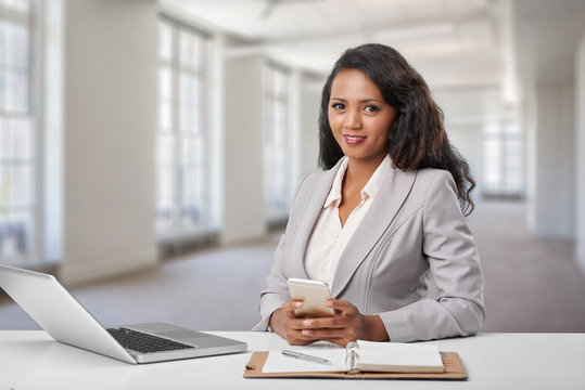 Young business woman at her workplace in office