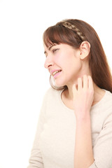 young woman scratching her neck