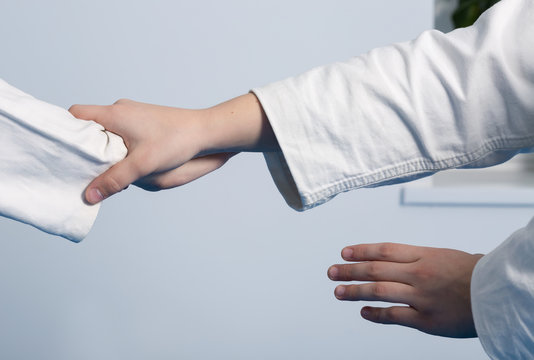 Hands of two girls practice Aikido on martial arts training
