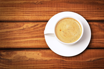 Cup of coffe on wooden background. Concept photo, top view