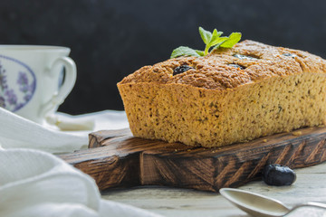 Banana pie with blueberries on a wite wooden table