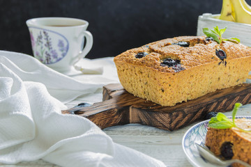 Banana pie with blueberries on a wite wooden table