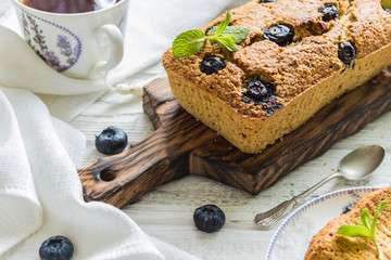 Banana pie with blueberries on a wite wooden table