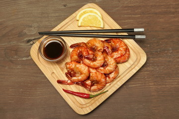 Grilled King Size Shrimps With Sauce Served On Wood Board