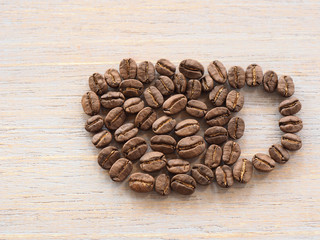 Roasted coffee crop on wooden, background texture