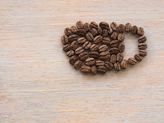 Roasted coffee crop on wooden, background texture
