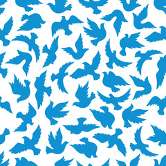 Fototapeta na wymiar Seamless pattern with blue silhouettes of flying dove birds over white background. Peace, religion theme or wallpaper design