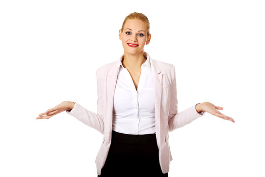 Young business woman shrugging with I dont know gesture