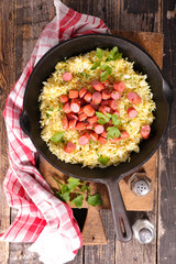 rice and sausage in pan