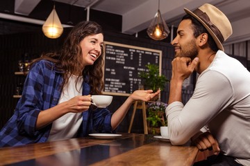 Couple talking and drinking coffee