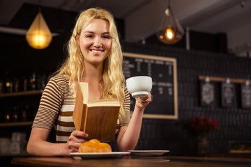Smiling woman reading a book