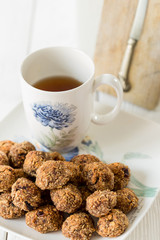 Tasty Gluten Free Apple Cookies with Black English Tea on Light White Wooden Background, Vertical