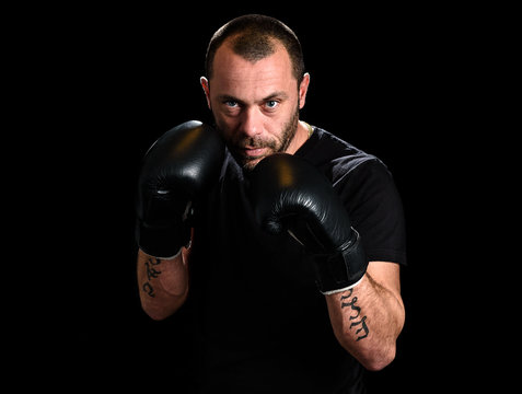 Portrait of male athlete boxer man looking aggressive with boxin