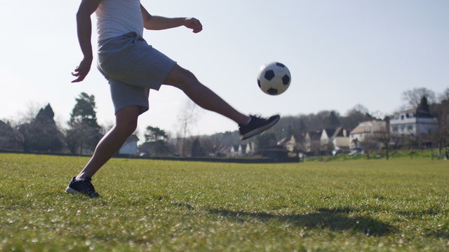 4K Legs of a man doing football kick ups, in slow motion