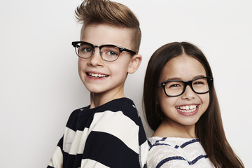 Happy friends wearing glasses in studio