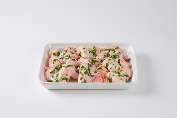 raw chicken wings in white baking dish