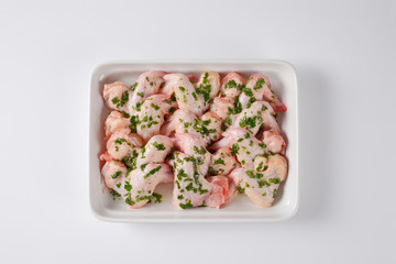 raw chicken wings in white baking dish