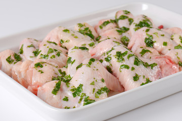 raw chicken wings in white baking dish