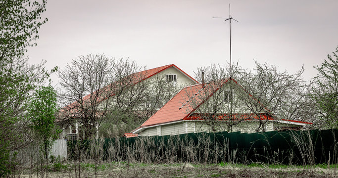 Cottage in gloomy weather. Rural landscape