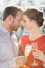 Young couple toasting glasses of champagne