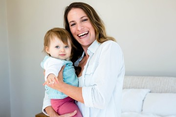 smiling woman holding an adorable baby