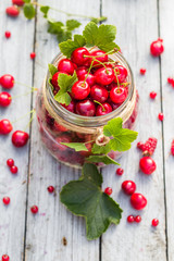Glass jar full of fruits cherries and currants