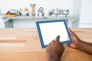 Man using digital tablet in kitchen