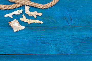 seashells and rope on blue boards, copyspace