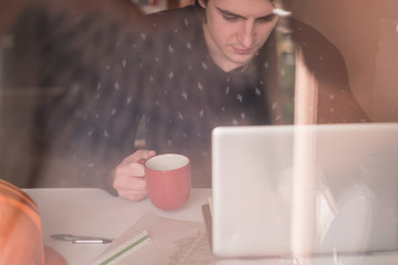 Waiting for inspiration. Thoughtful young man sitting at his wor