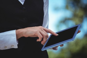 Smiling waitress taking an order with a tablet