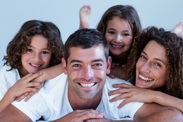 Portrait of a family lying on bed