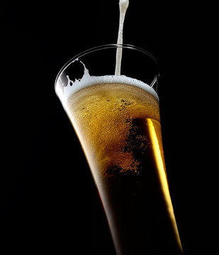Glass Of Beer With Foam On A Black Background
