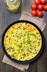 Omelette with green onion in frying pan