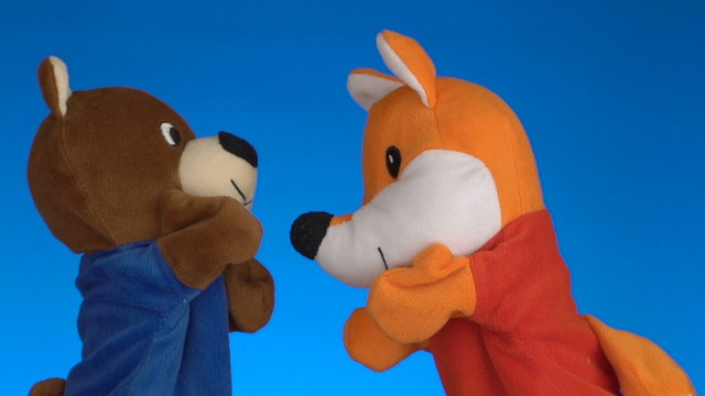 Funny soft puppets toys on blue background