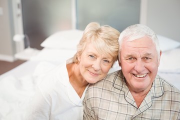 Portrait of happy senior couple in nightwear